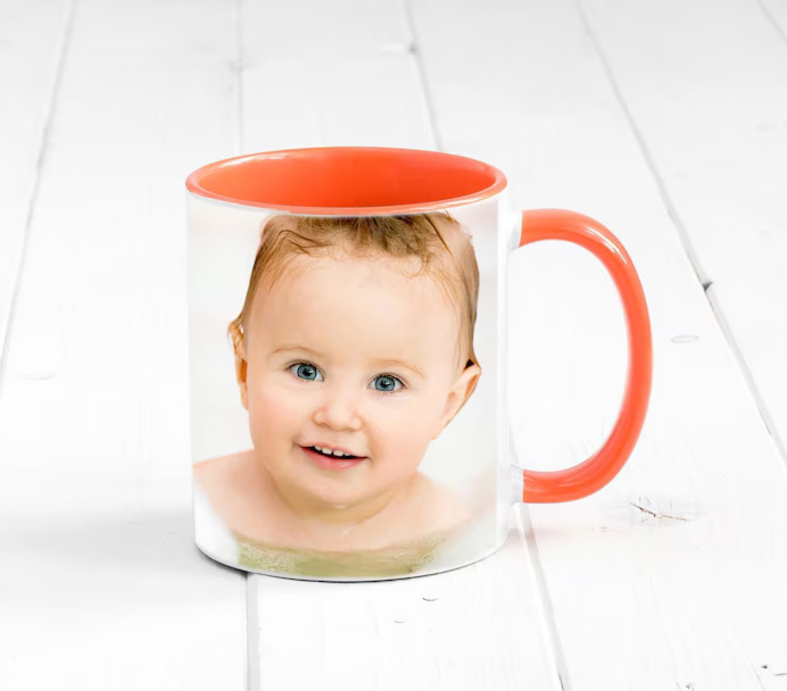 small-orange-cup-with-bright-orange-handle-printed-face-baby_143092-13310